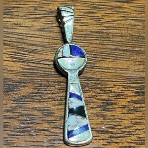 Native American sterling silver pendant featuring multistone inlay signed